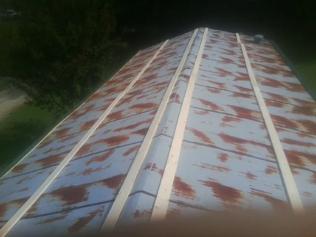 Rusted metal roof panels with new wood purlins before replacement — Storm Damage Roof Repair in Bradley Beach by Roofing Brothers