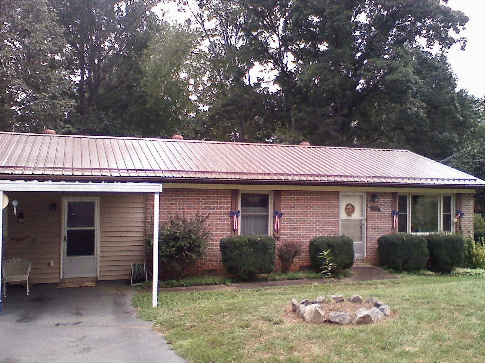 Bronze metal roof and carport on a brick ranch home — Roof Repair work by our crew in Bradley Beach