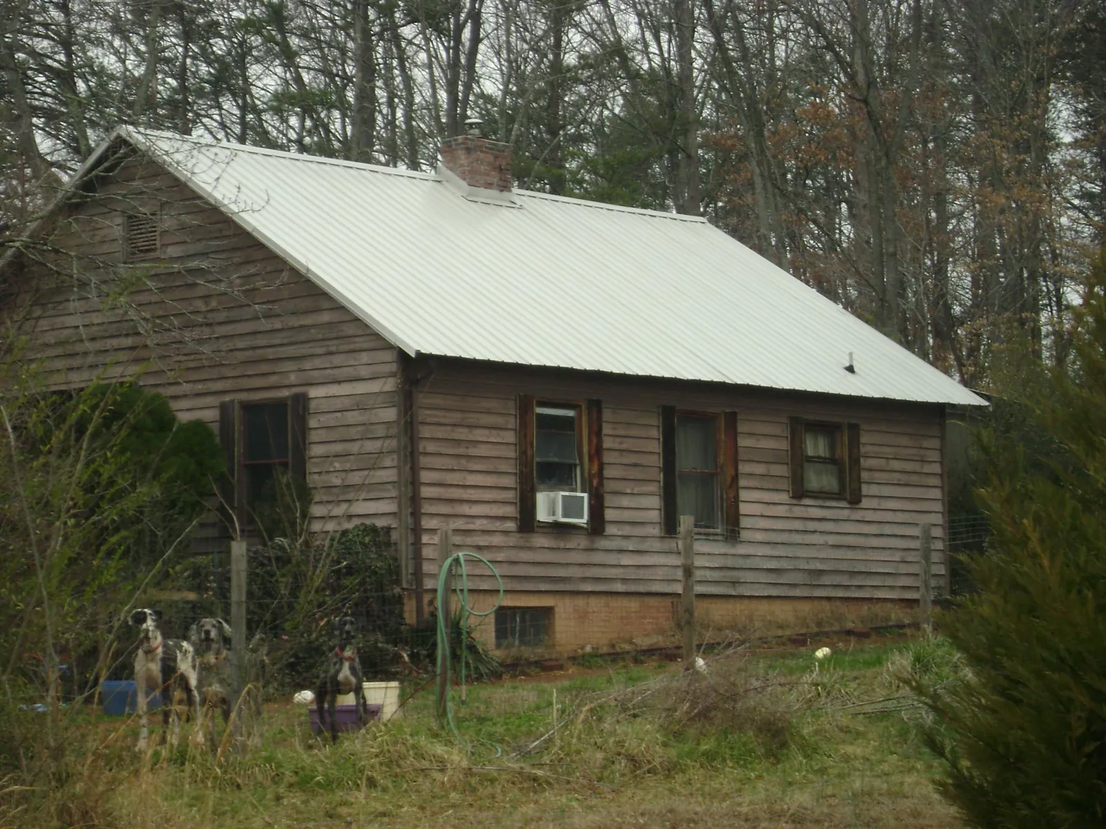 White metal roof on an old wood sided farmhouse, from a Metal Roof Installation job in Bradley Beach